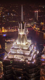 Aerial view of illuminated buildings in city at night