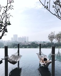 Man relaxing in hammock at lake