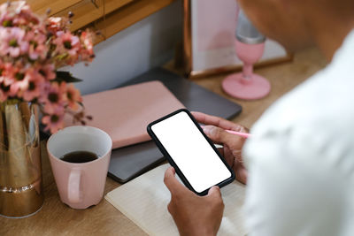 Midsection of woman using mobile phone