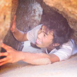 High angle portrait of smiling boy lying down