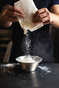 Cropped hand of person preparing food