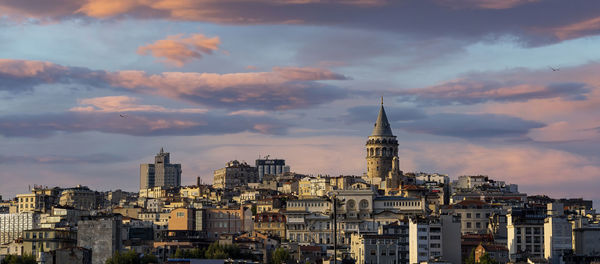 Cityscape of a part of istanbul city showing homes and galata tower at sunset.