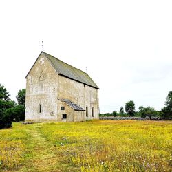 Abandoned building on field against sky