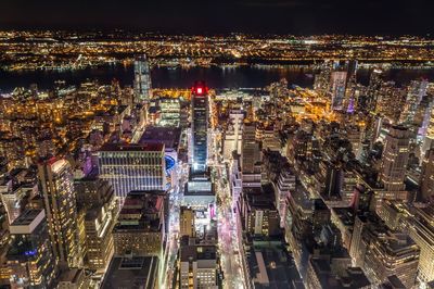 Aerial view of city lit up at night