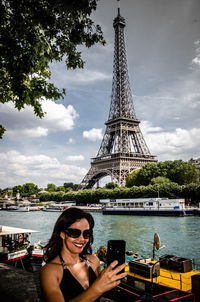 Young woman using mobile phone in city