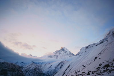 Scenic view of snow covered mountains against sky