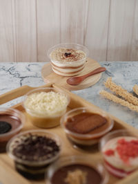 Desserts on a cup served on the table with wooden ware