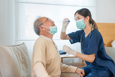 Female doctor examining patient at clinic