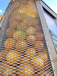 Close-up of yellow building against sky