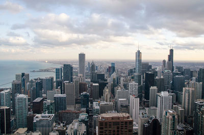 High angle view of cityscape against cloudy sky