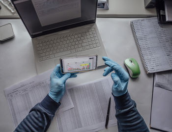 Cropped hand of woman using digital tablet