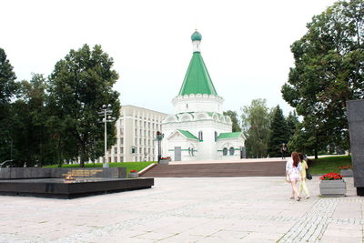 People at temple against building