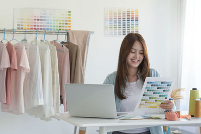 Young woman using laptop at office