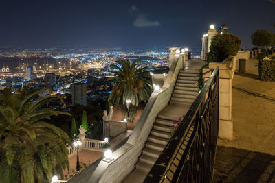 High angle view of illuminated buildings against sky at night