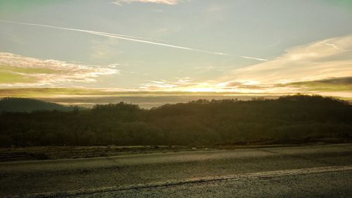 Landscape against sky at sunset