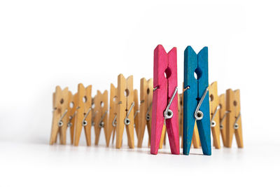 Close-up of clothespins on clothesline against white background