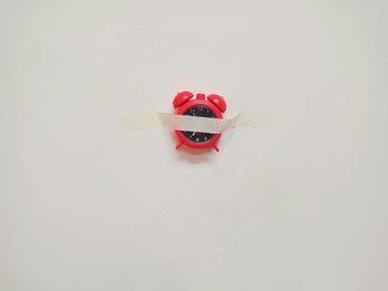 Close-up of red toy against white background