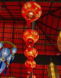 Low angle view of illuminated lanterns hanging on ceiling