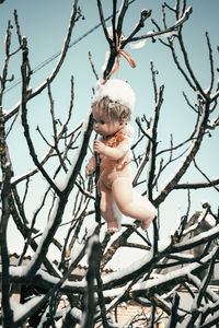 Full length of shirtless boy against bare tree