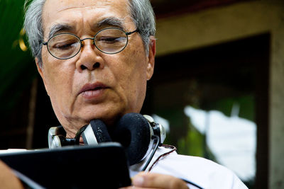 Close-up of senior man using mobile phone