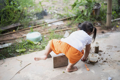 High angle view of boy sitting on field