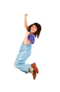 Happy girl with arms raised against white background