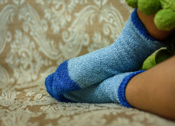 Close-up of child wearing blue socks