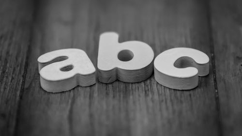 Close-up of alphabet abc on wooden table