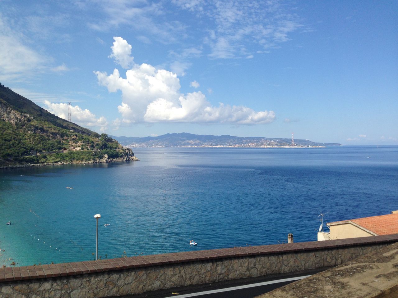 water, sky, sea, tranquil scene, scenics, tranquility, blue, beauty in nature, mountain, cloud - sky, nature, cloud, beach, built structure, idyllic, day, shore, coastline, architecture, outdoors