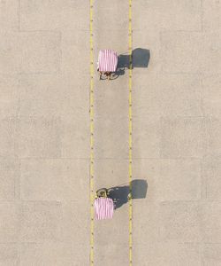 Aerial view of food trucks on road in city during sunny day