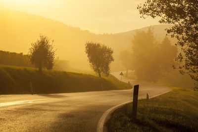 Empty road along countryside landscape