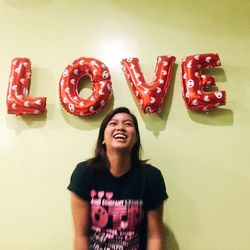 Young woman smiling heart shape with text