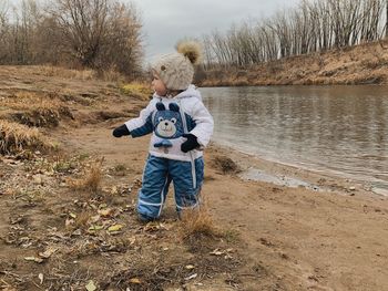 Rear view of boy standing on beach