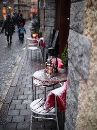 Snow covered table and chairs at sidewalk cafe