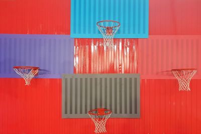 Basketball hoop on abstract red wall