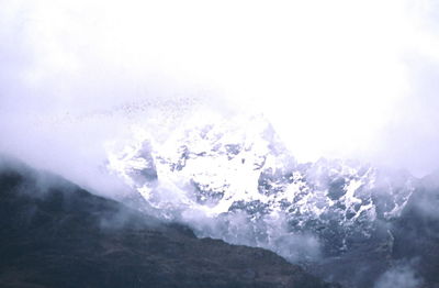 Close-up of snow on mountain against sky