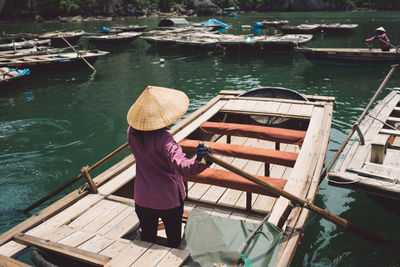 Rear view of man rowing boat in sea