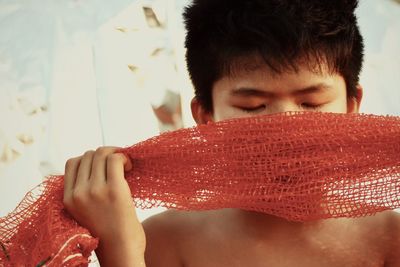 Close-up of boy holding fishing net