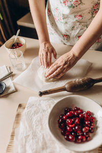 Midsection of woman preparing food on table