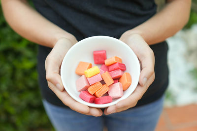 Midsection of man holding pills