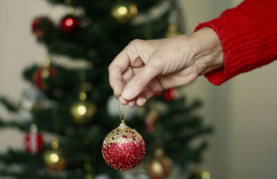 Cropped hand holding christmas bauble