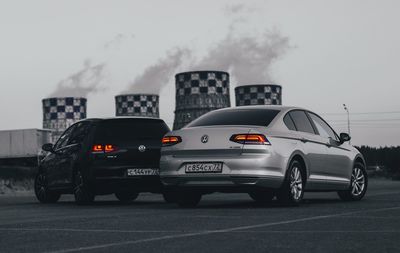 Cars on road against sky in city