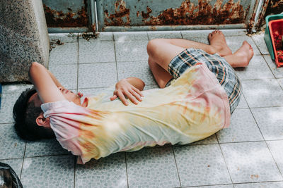 Homeless man sleeps on the street , bangkok thailand.