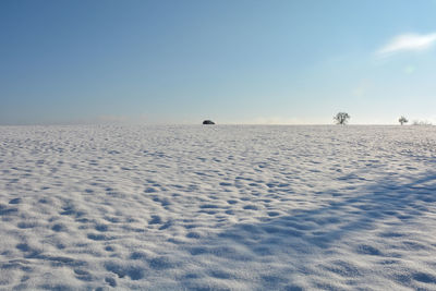 Scenic view of land against clear sky during winter