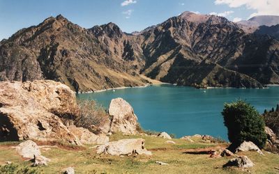 Scenic view of lake and mountains against sky