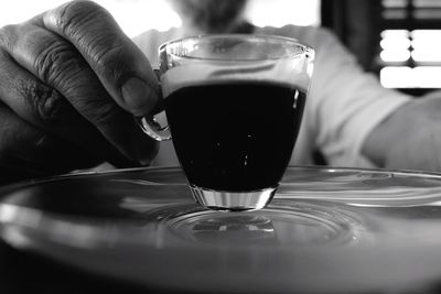 Close-up of hand holding espresso