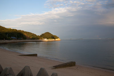 Scenic view of sea against cloudy sky