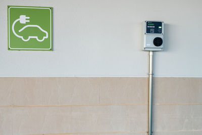 Close-up of information sign on wall