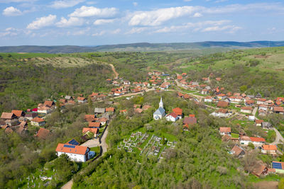 Aerial view of village road passing near an agricultural field. spring view of  countryside hills
