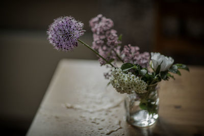 Close-up of purple flower vase on table